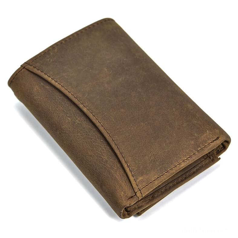 side profile of gothic dragon leather wallet displaying distressed texture, neat stitched edges, and antique brass chain attachment