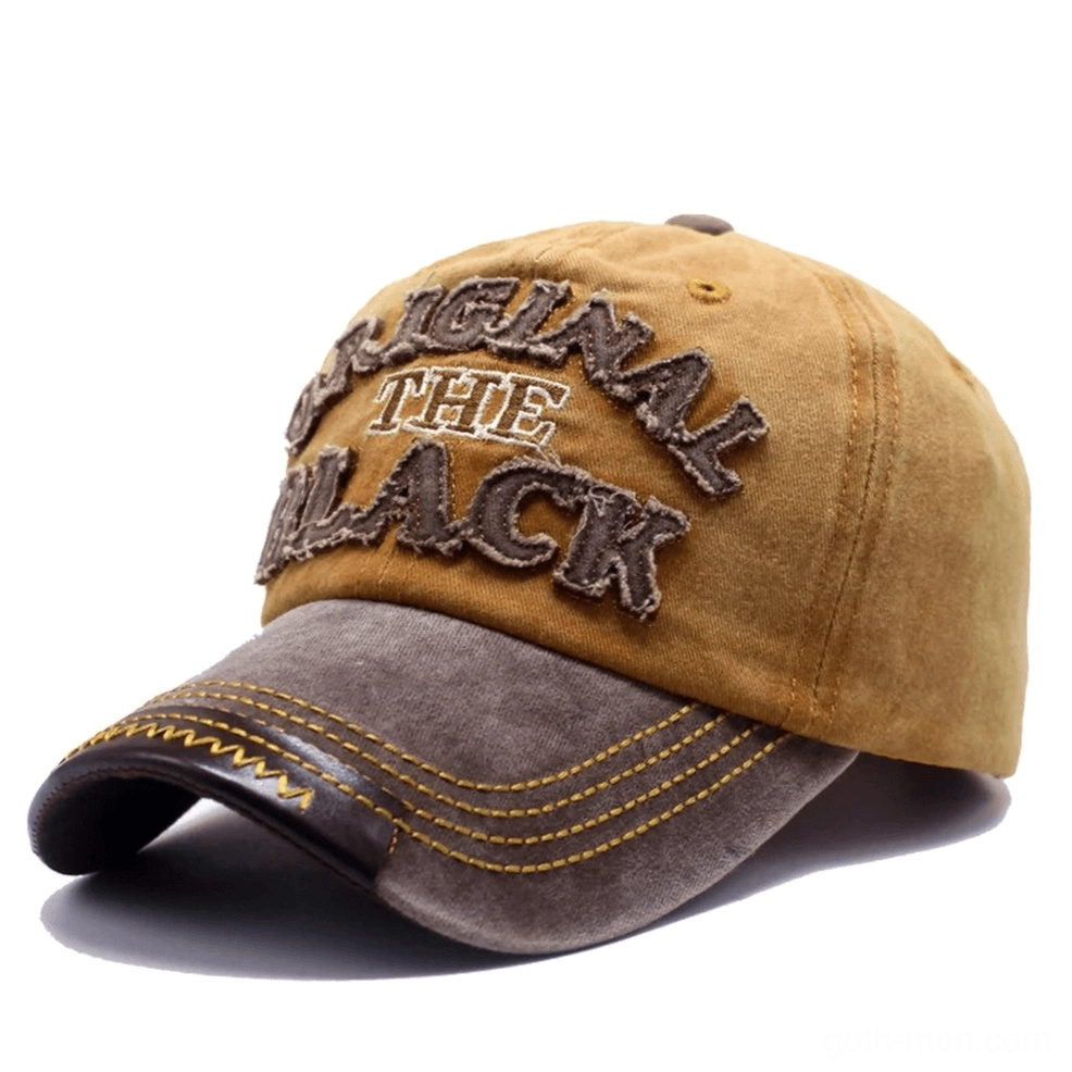 Tan and brown washed gothic baseball cap with yellow contrast stitching, contrast brim, and embroidered letter accent