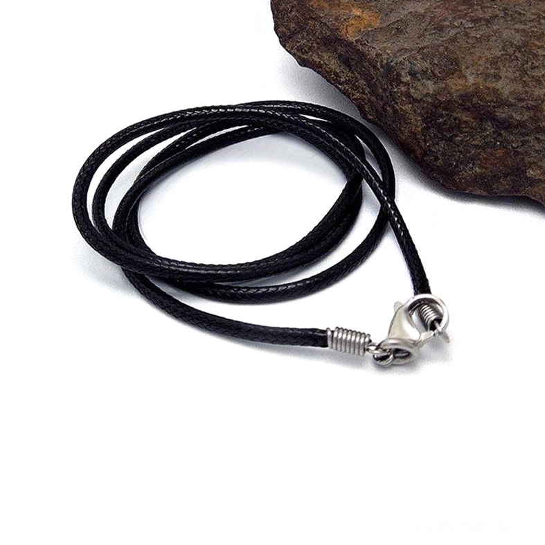 Black braided wax rope necklace low angle side view showing compact coil and silver metal fastener