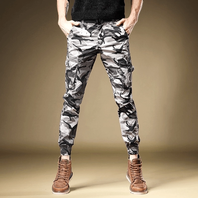Gray camouflage slim-fit cargo pants full-body front view on male model showing multi-pocket utility design