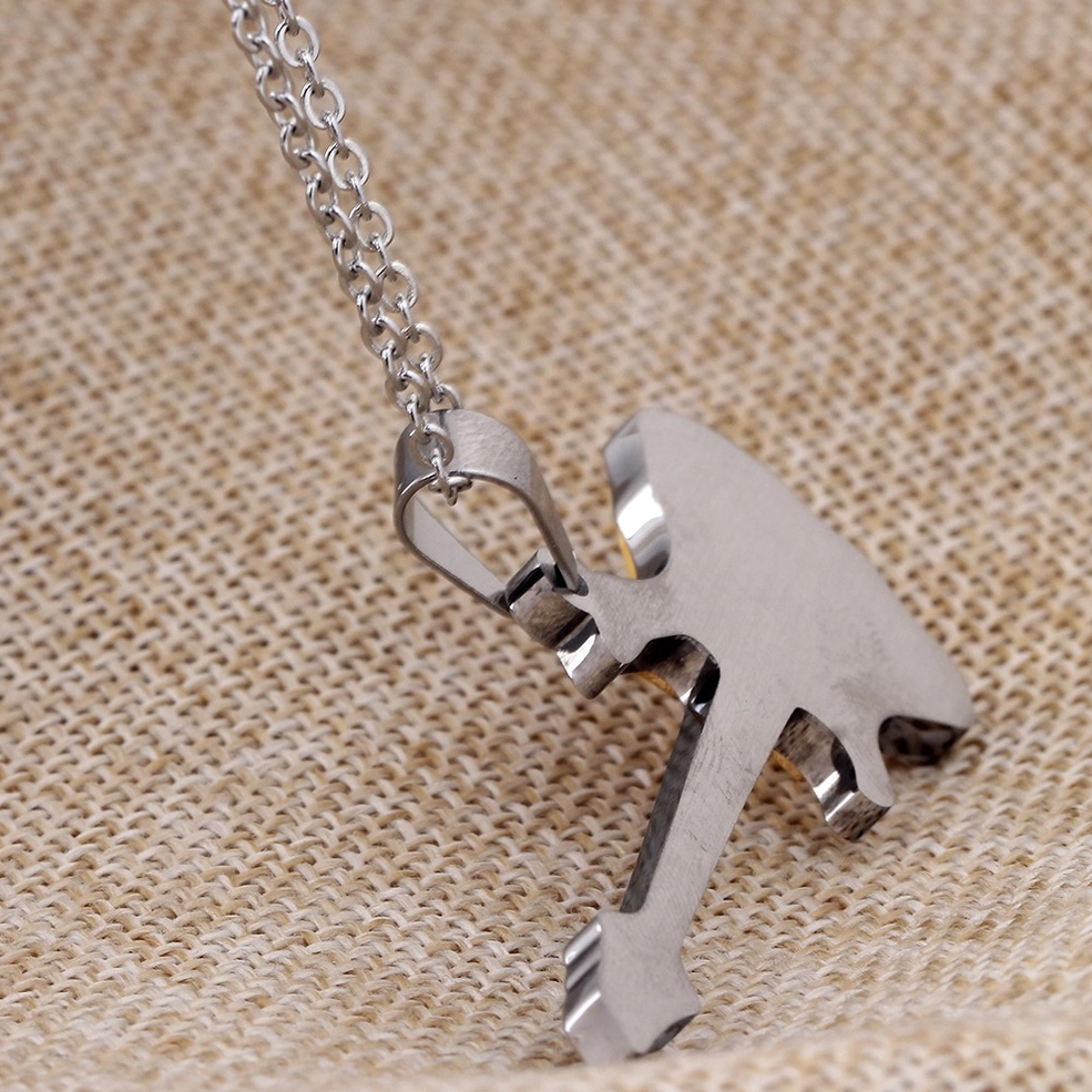 Reverse side of silver guitar pendant necklace showing brushed metal finish and polished surface detail