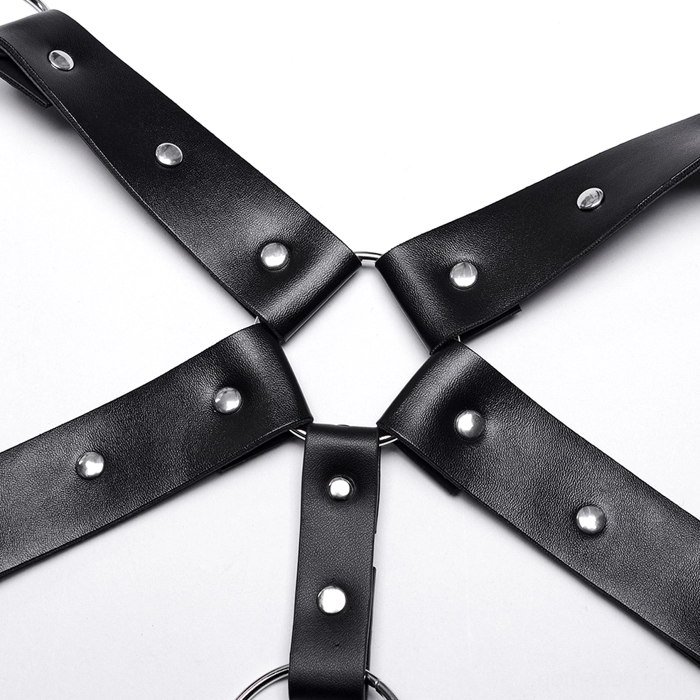 Flat lay close-up of black PU leather harness strap junction showing metal eyelets and leather texture
