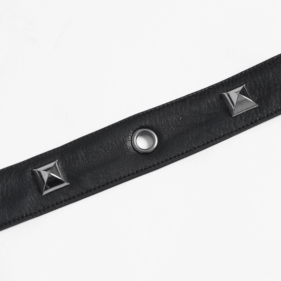 Black leather harness waist panel and buckle system close-up, showing structural support and industrial hardware detail