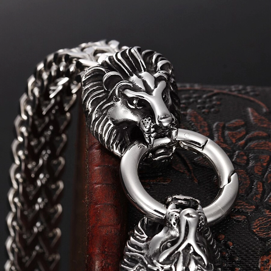 Close-up detail of sculpted lion head clasp on gothic stainless steel bracelet, carved features and polished finish