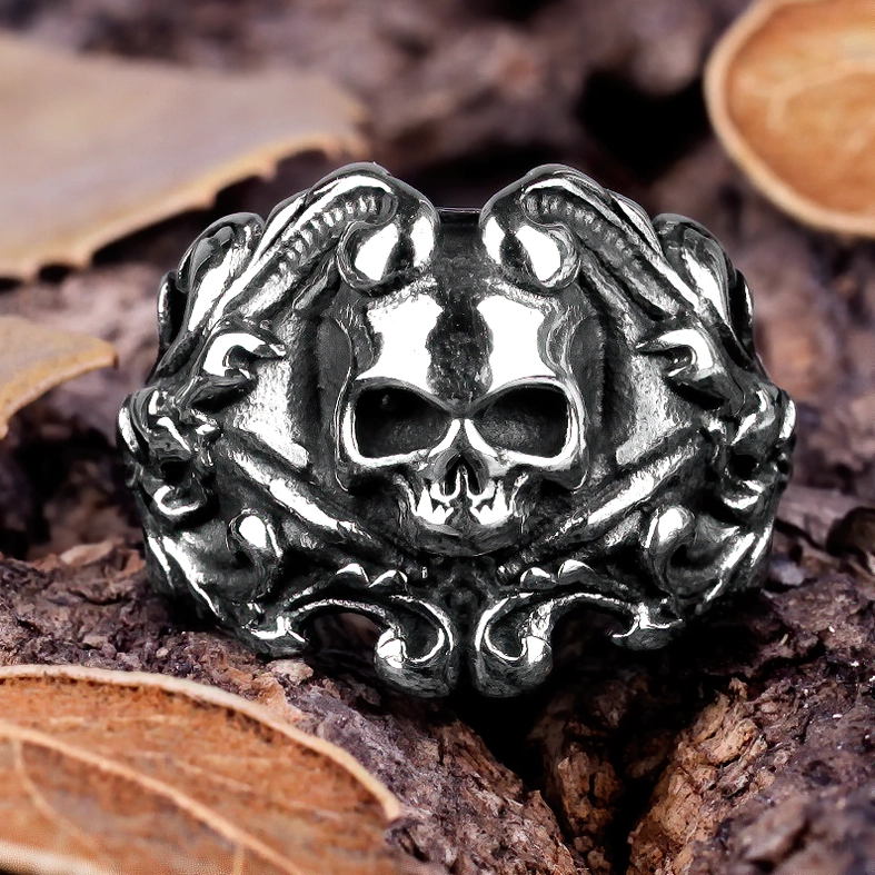 Aged silver skull ring nature background intricate carved details memento mori jewelry close-up