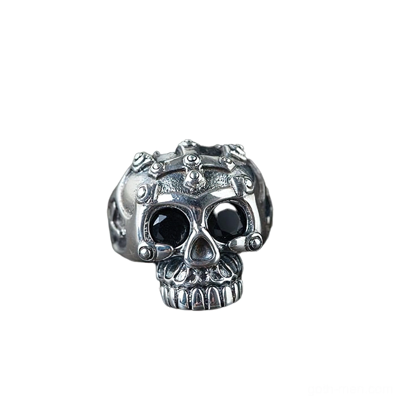 Memento mori skull ring front direct view featuring skeletal teeth detail and black gemstone eyes