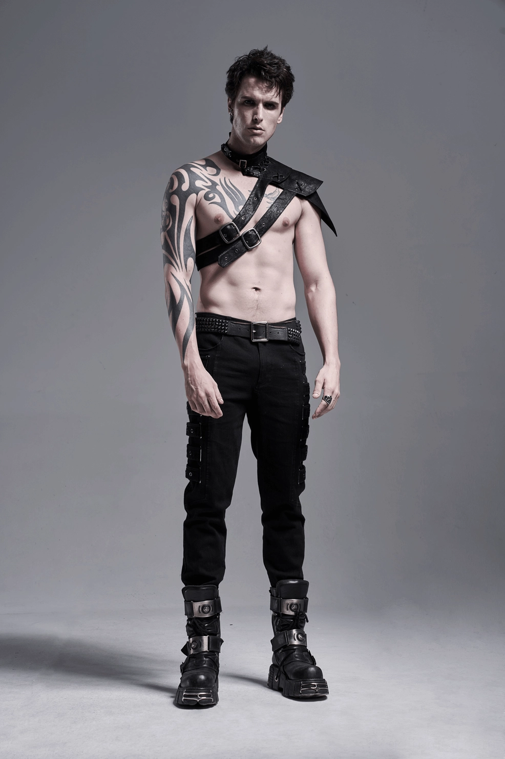 Men's black gothic cargo pants with metal eyelet adjustable straps lifestyle presentation
