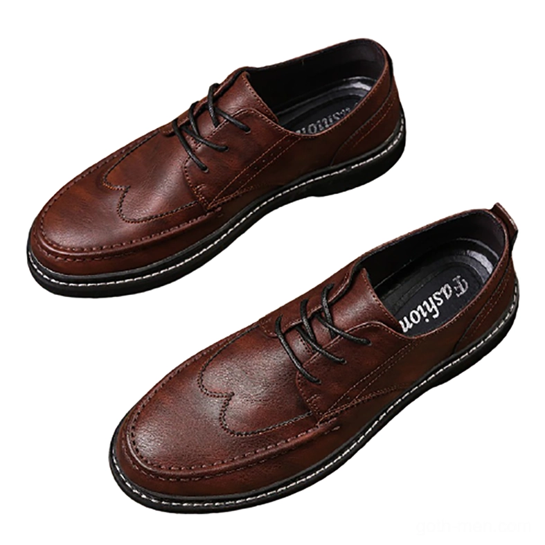 Brown lace-up gothic men's leather shoes with brogue toe styling and non-slip rubber outsole, overhead three-quarter view