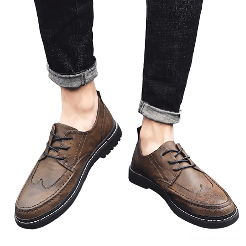 Dark brown gothic leather shoes for men paired with rolled denim, casual lace-up oxford style, flat overhead shot