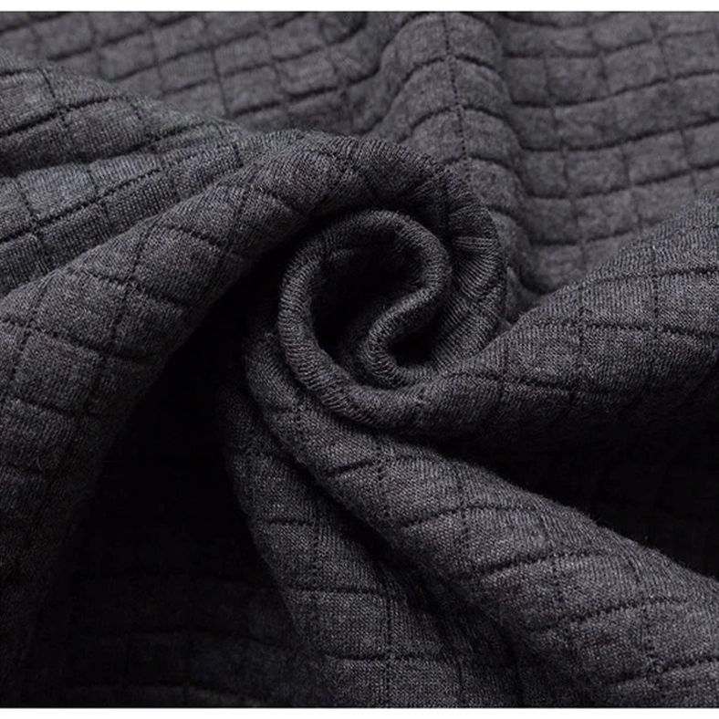 Men's dark aesthetic quilted hoodie showing construction quality, grid pattern, and structured design details