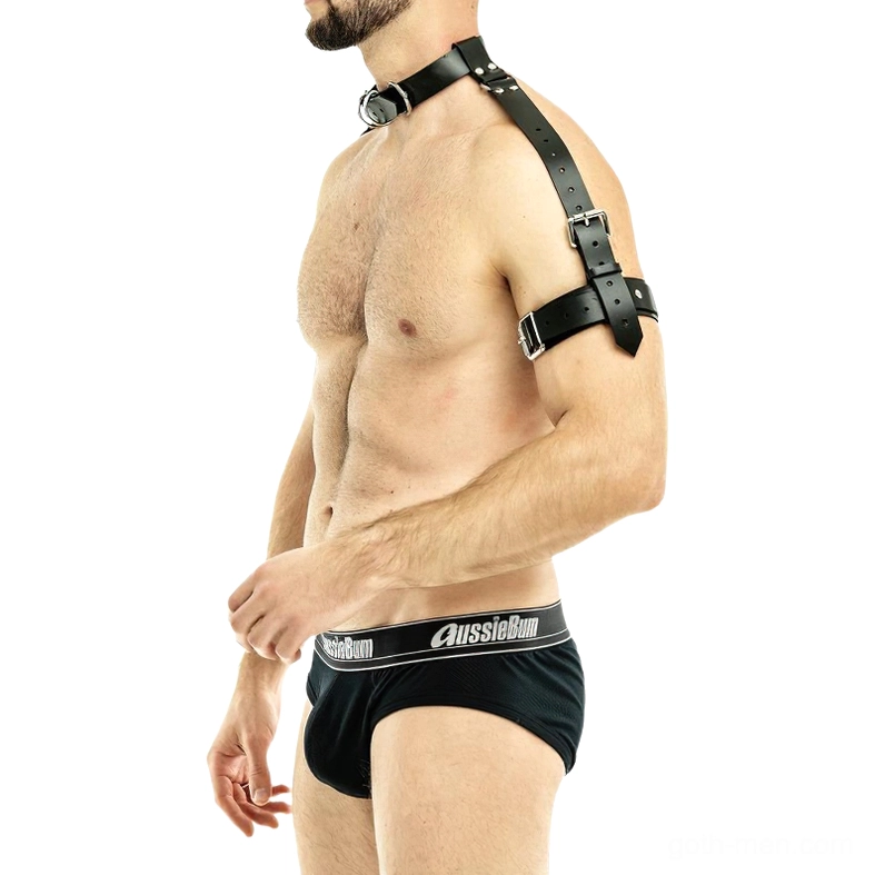 Black faux leather gothic body harness with single arm strap design on shirtless male model, right side profile view