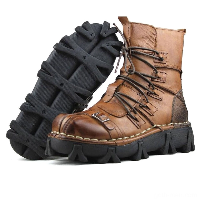 Distressed brown leather gothic rocker boots with contrast stitching and multiple lacing straps, side profile revealing rugged outsole and aged finish