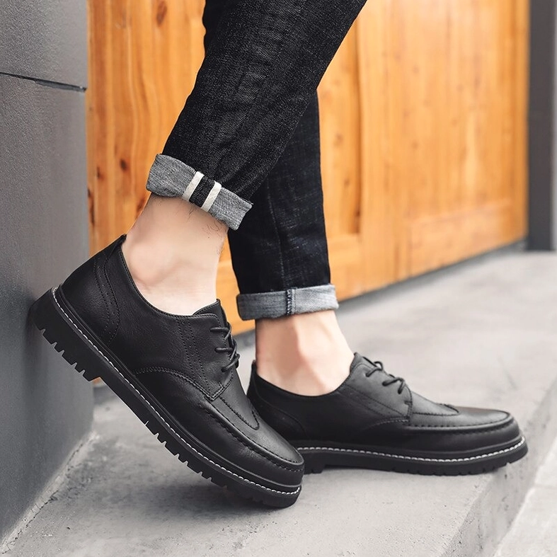 Men's gothic leather dress shoes elegant styling presentation on neutral background