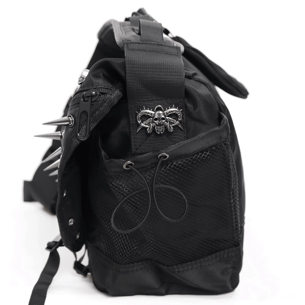 Detail view of adjustable shoulder strap mechanism and metal attachment points on black gothic bag