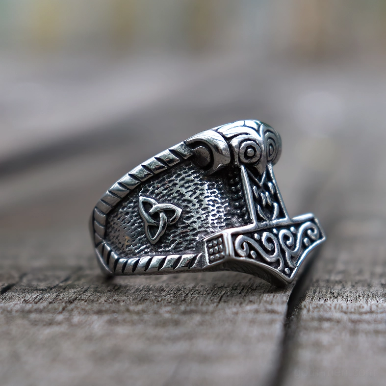 Mjolnir Thor's hammer Celtic ring side profile on wooden background - vintage silver patina effect and trinity knot engraving