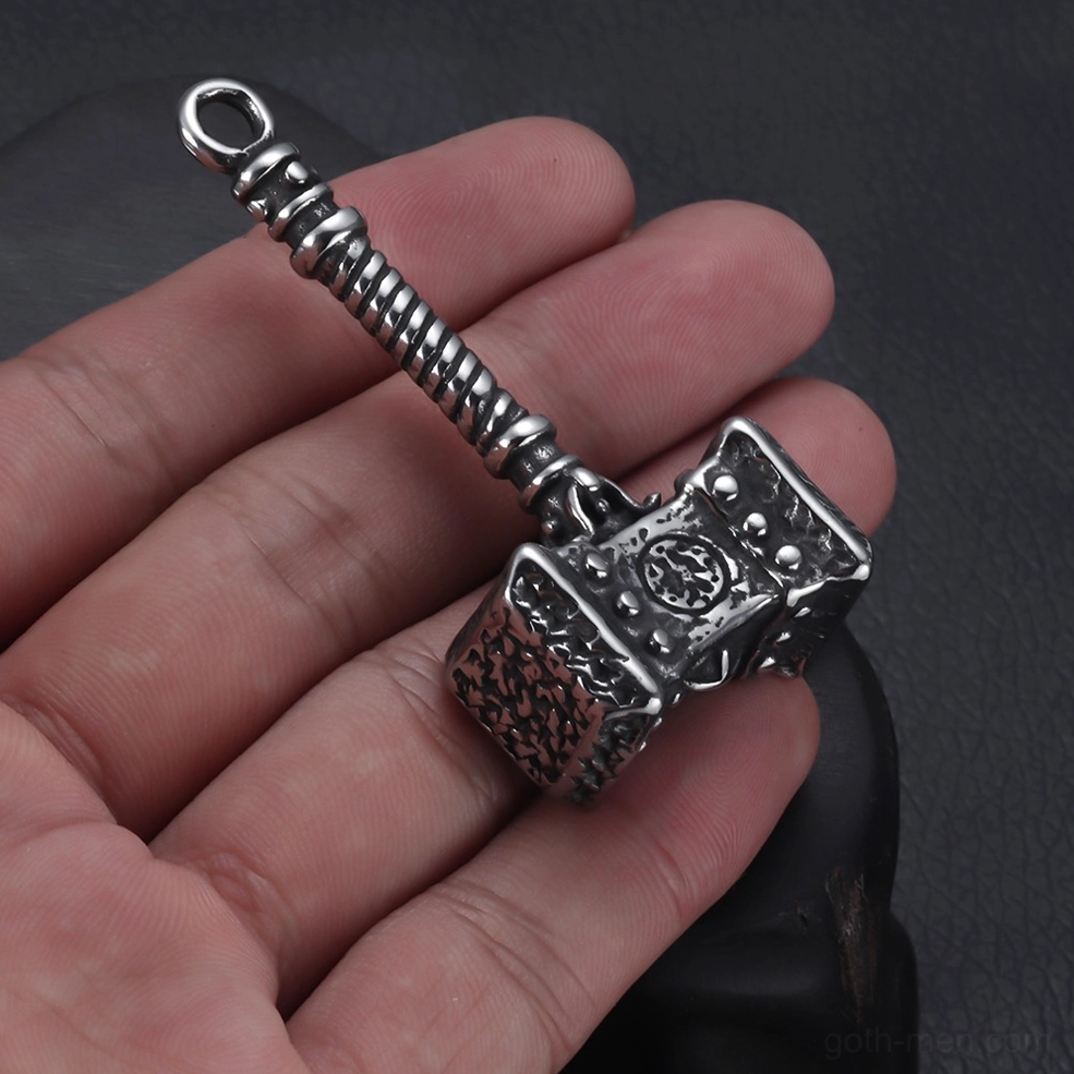 Mjolnir hammer pendant worn in human hand - first-person perspective showing real-world handheld scale on dark background