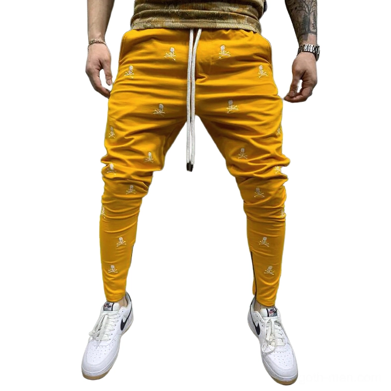 Mustard yellow skull printed gothic lace-up pencil pants with drawstring waist, bold alternative mens fashion trousers