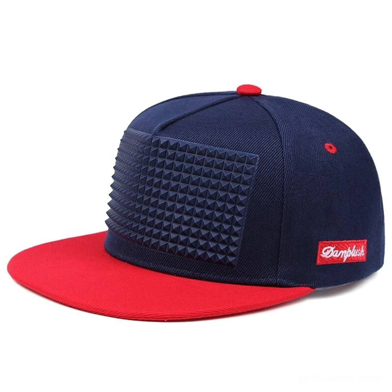 Navy blue and red gothic spike snapback baseball cap with pyramid studs, flat brim, three-quarter angle view