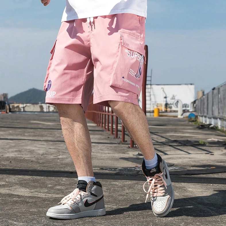 Pink cargo shorts waistband detail showing elastic construction and drawstring cord