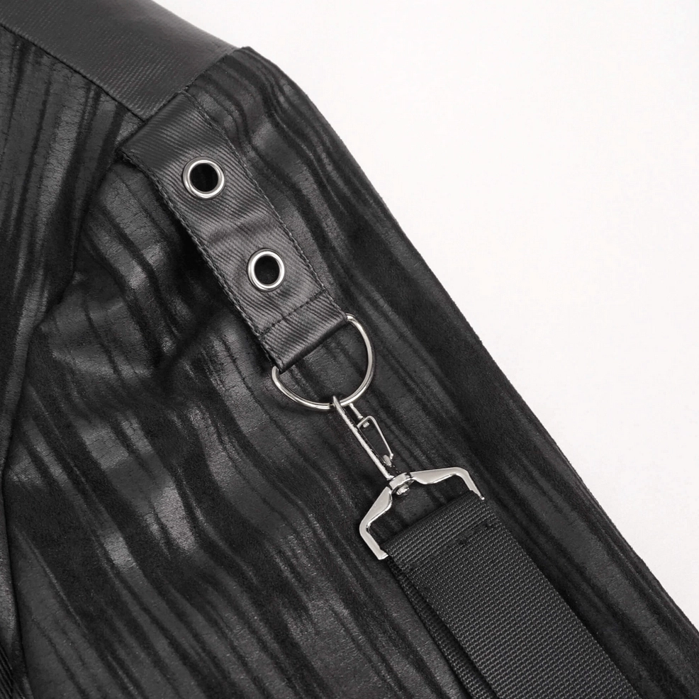 Texture detail of crinkled faux leather and metal hardware on black punk jacket