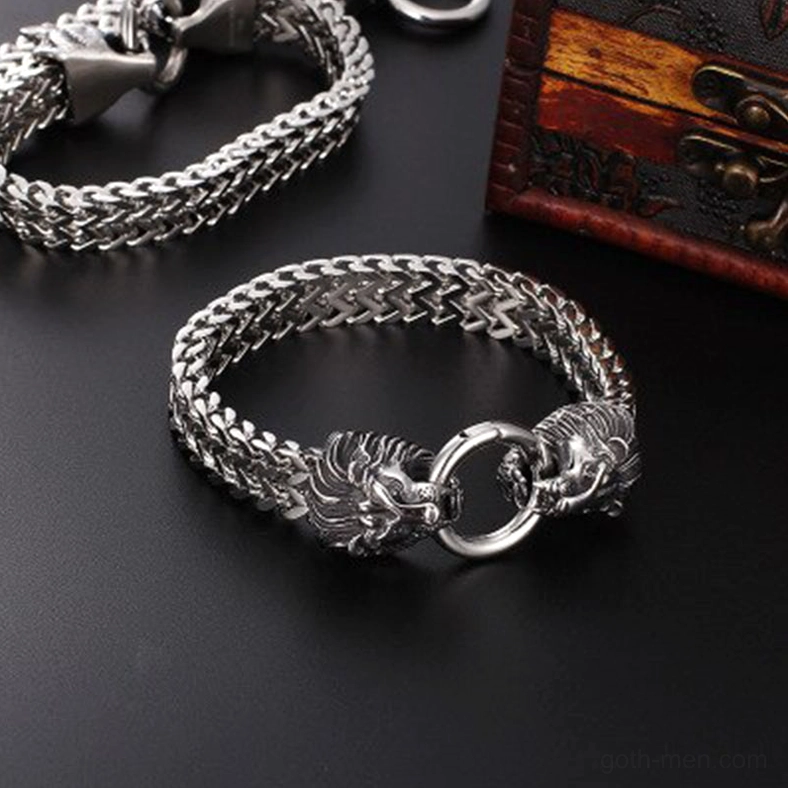 Multiple gothic lion head chain bracelets displayed together, polished stainless steel, vintage wooden background