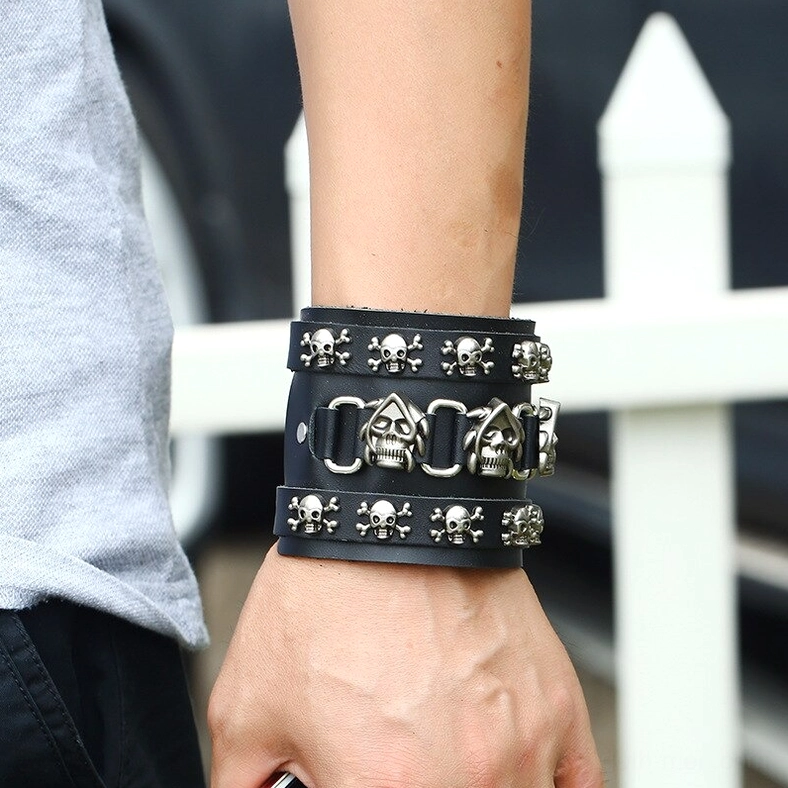 Punk rock skull leather bracelet flat lay display showing dual adjustable straps and antique silver metal skull decorations
