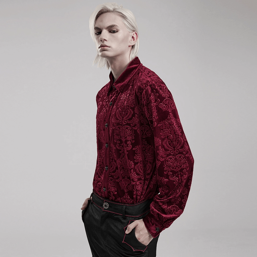 Side angle view of red gothic velvet formal shirt on model showing burgundy damask pattern and shirt silhouette