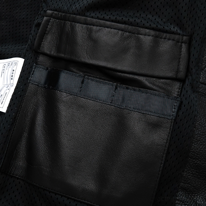 Shoulder seam and orange stripe detail on black pebbled leather gothic jacket