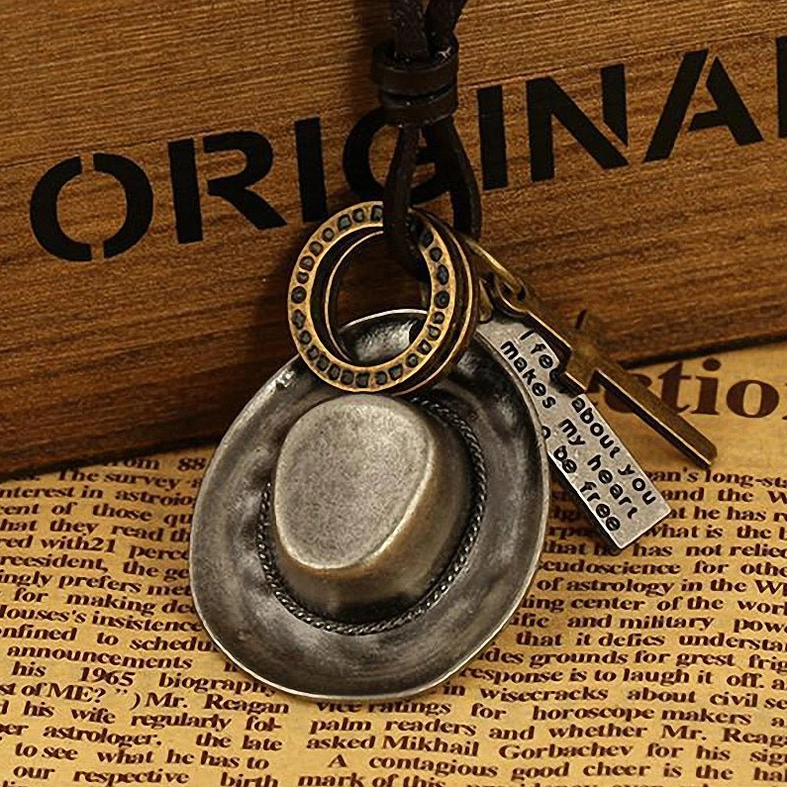 Silver-gray vintage cowboy hat pendant necklace with engraved metal details, gothic western rebel aesthetic