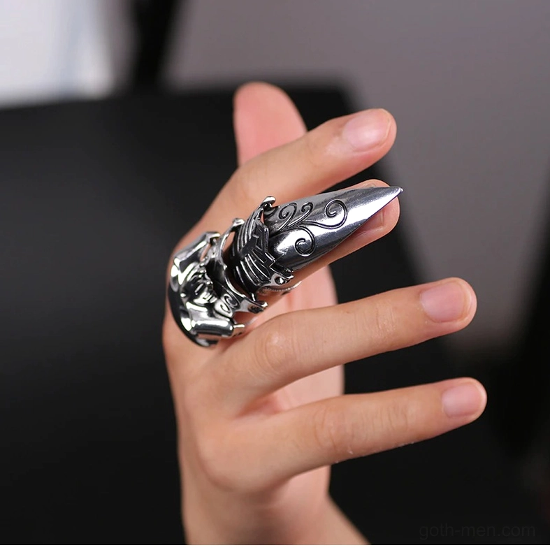 Silver gothic skull claw ring - side close-up on dark background highlighting metalwork and articulation