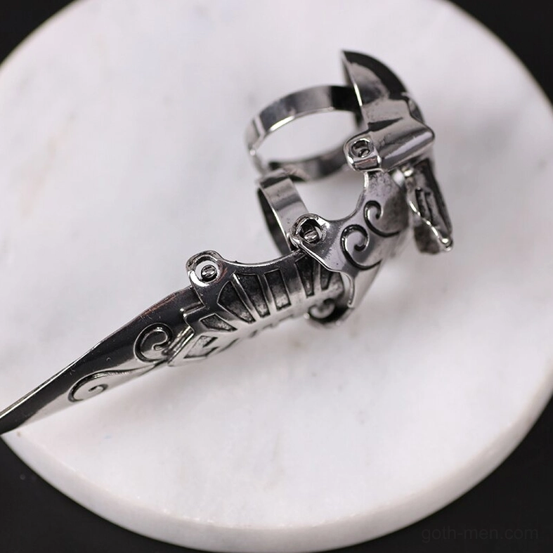 Silver gothic skull claw ring - overhead angled view on marble background showing articulated jointed design