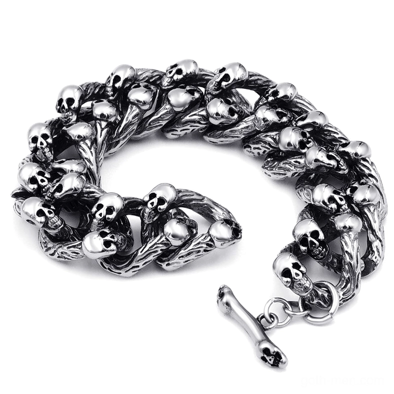 Heavy gauge skull chain bracelet showing bone-shaped toggle clasp detail and robust construction of twisted links with integrated skull accents
