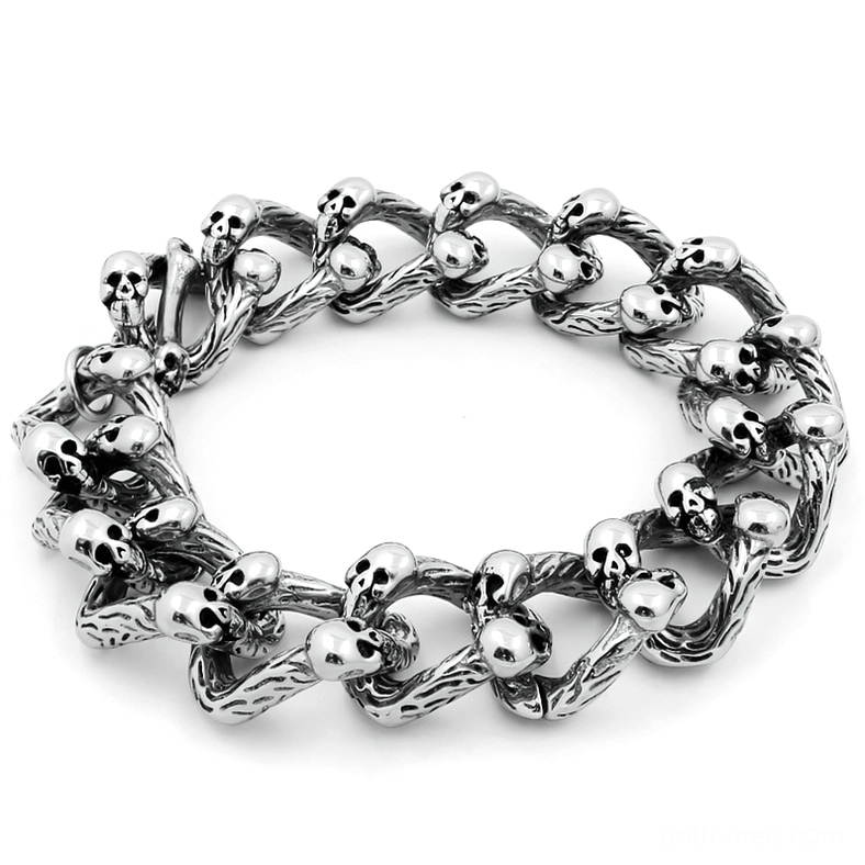 Silver skull curb chain bracelet double-row flat lay overhead view showing intricate twisted links with multiple skull accents and antique distressed finish