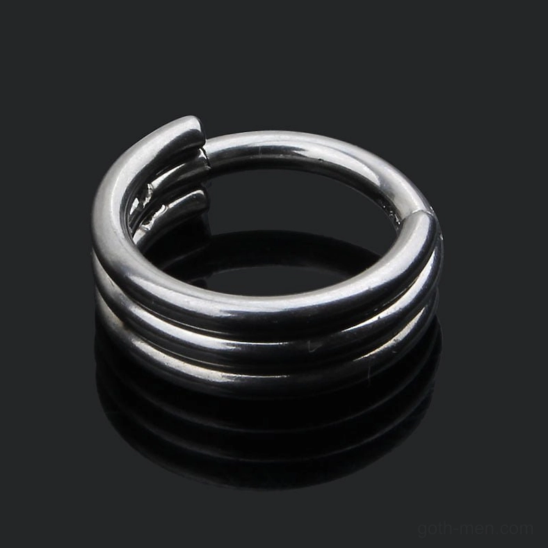 Silver gothic nose ring from top-down view - overhead perspective revealing triple stacked bands and compact disc-shaped design
