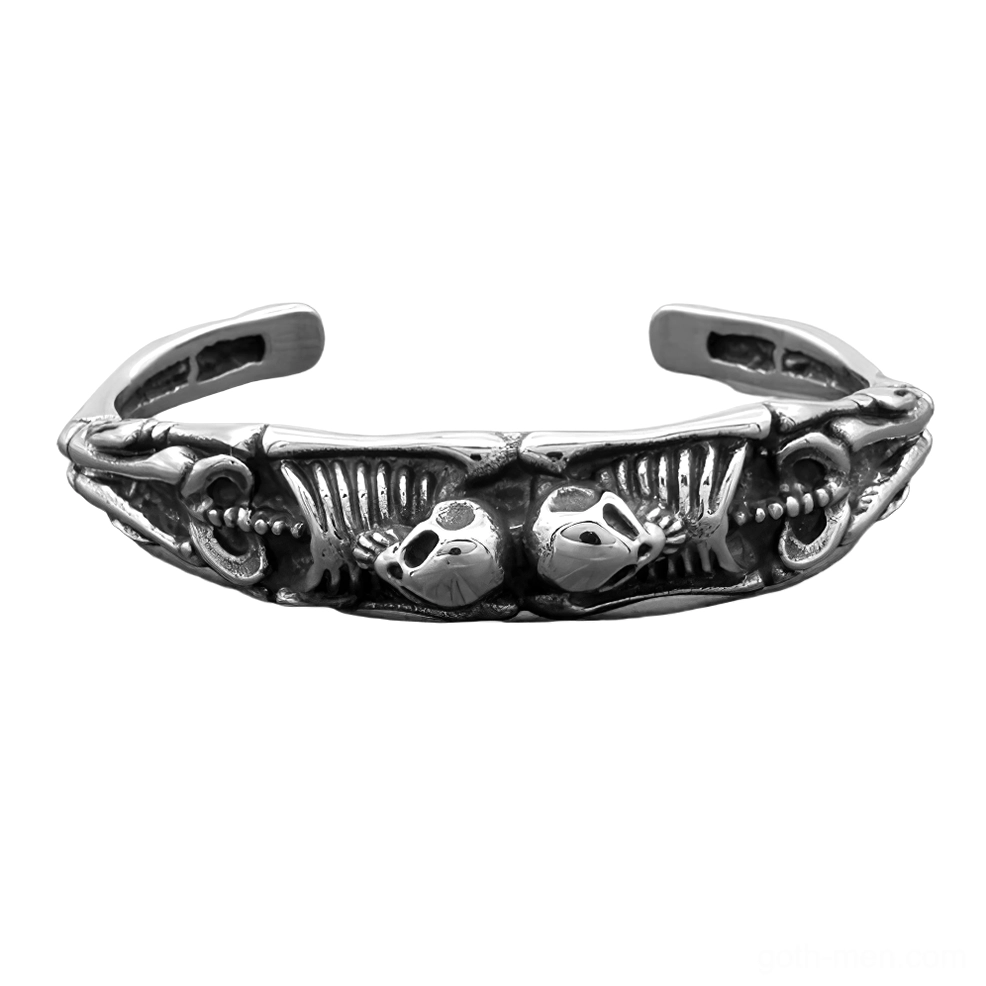 Top view of skeleton cuff bracelet displaying dual skull motifs and full skeletal anatomy carving – stainless steel gothic bracelet