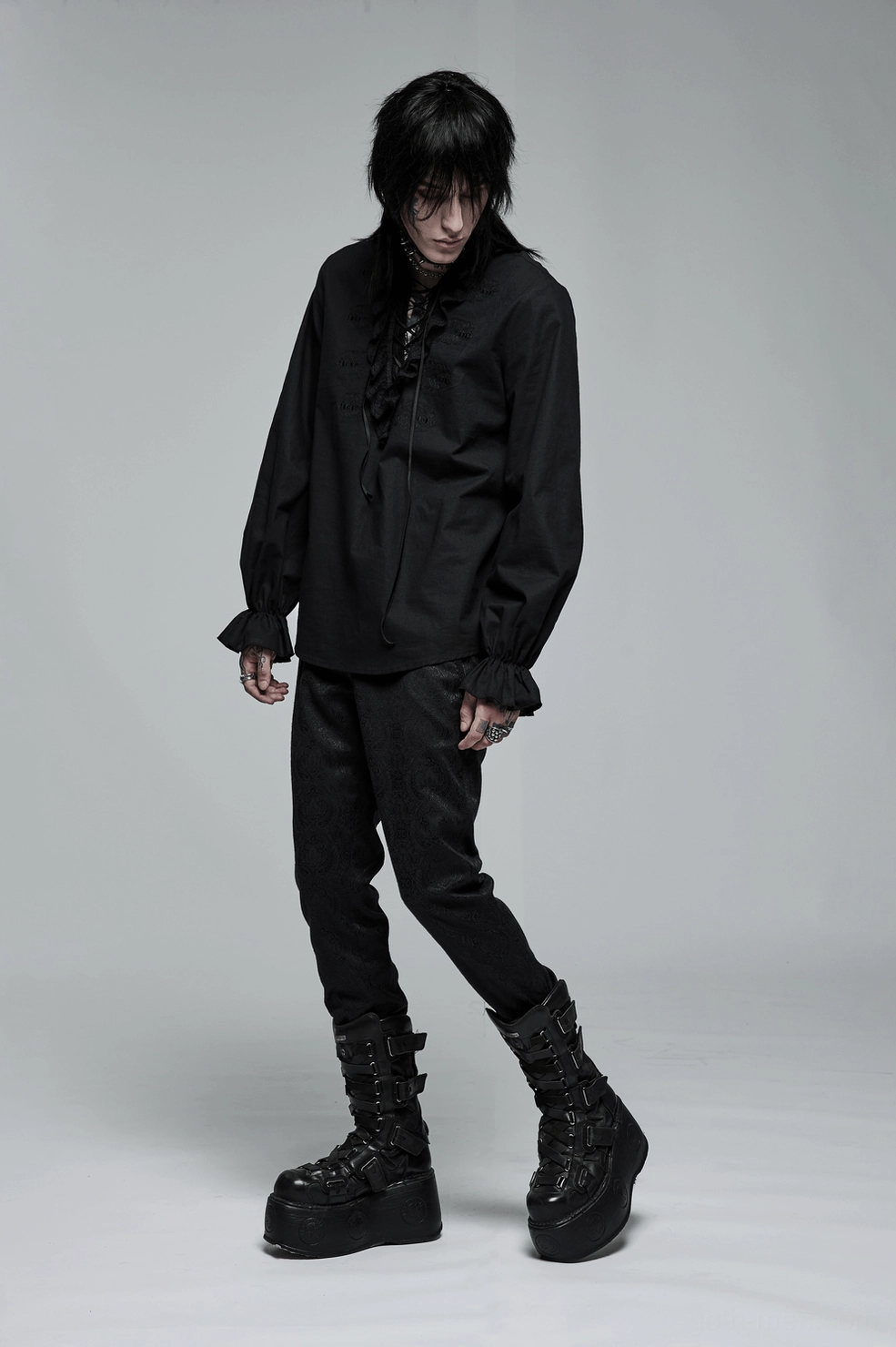 Black skeleton embroidered gothic shirt showing ruffled cuffs lace detailing and loose silhouette on model