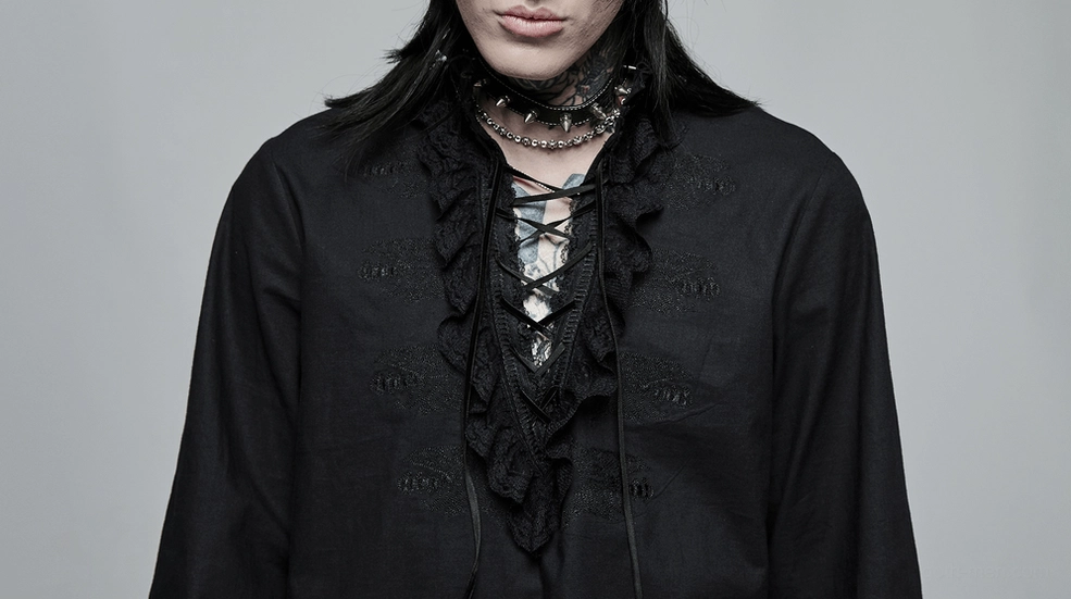 Close-up front view of skeleton embroidered gothic shirt worn by male model showing layered lace neck trim detail