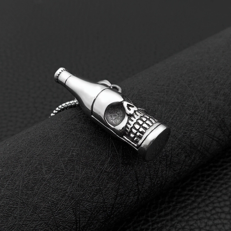 Polished stainless steel skull bottle gothic pendant close-up on dark leather surface