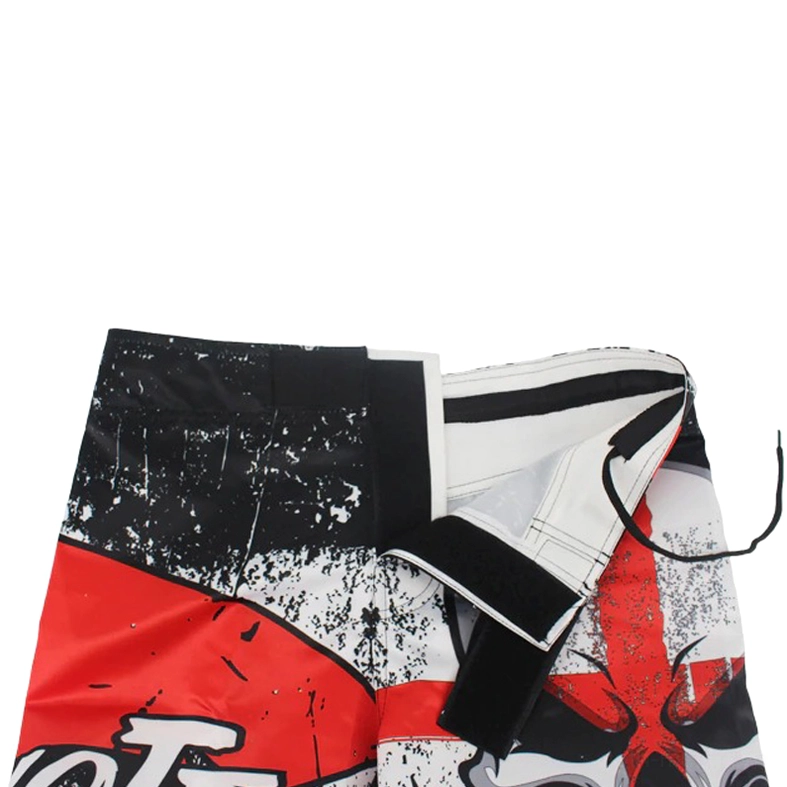 Flat lay close-up of distressed black gothic shorts emphasizing large centered red skull cross print and fabric distressing