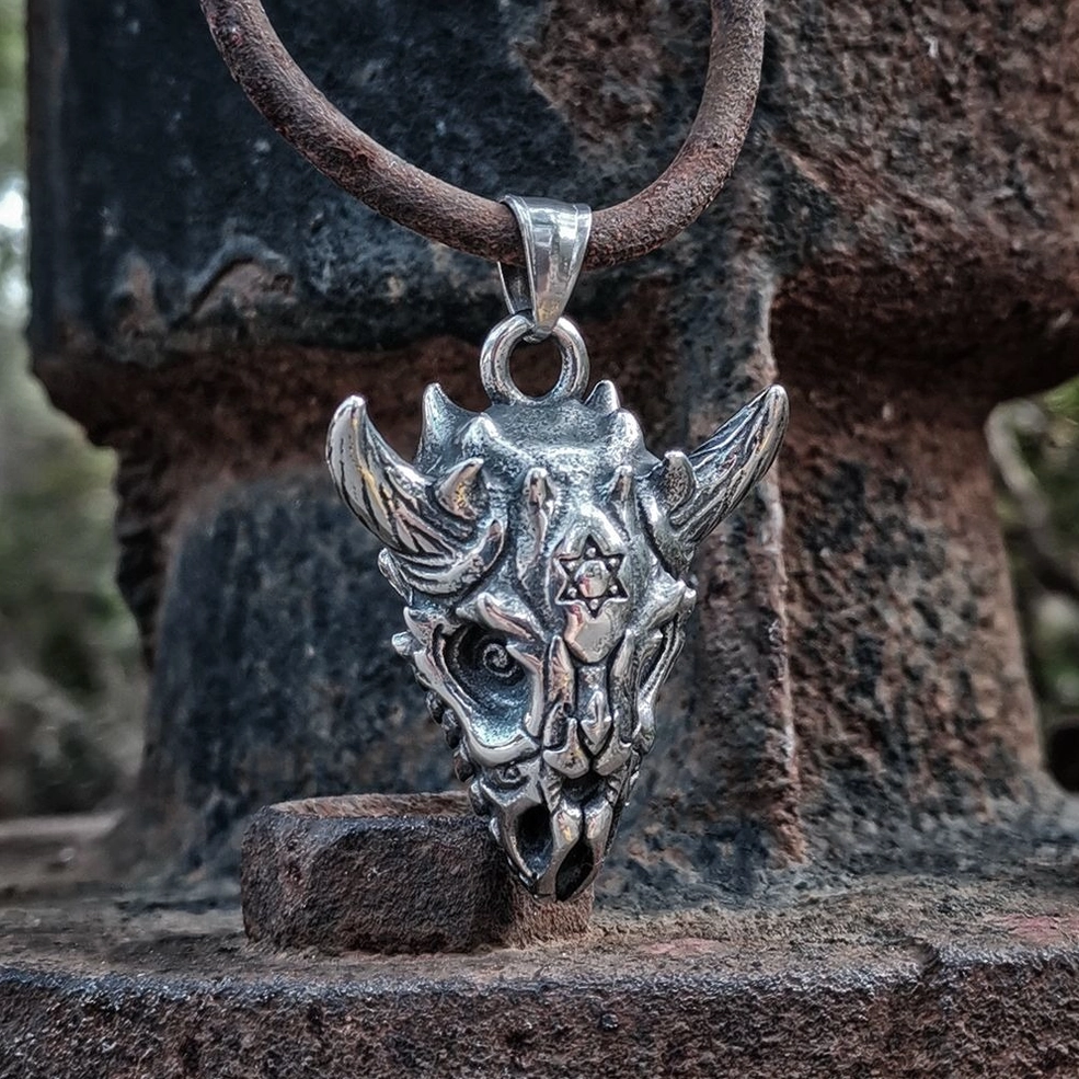 Dark oxidized skull pendant on brown leather cord three-quarter view showing aged silver metal aesthetic