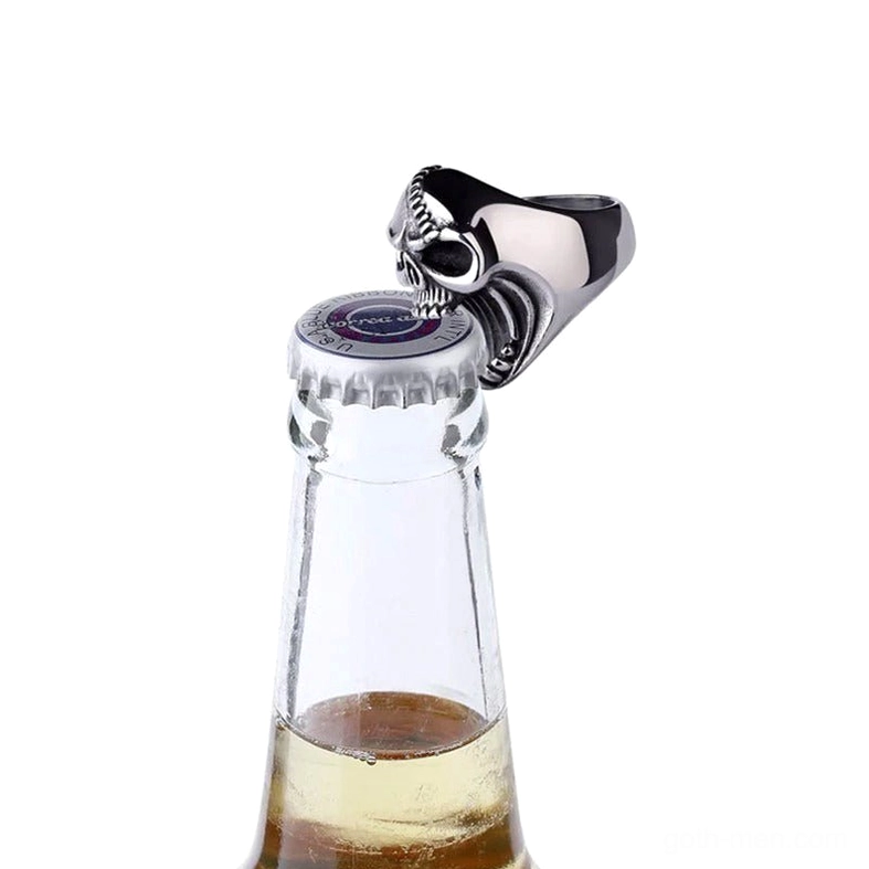 Skull bottle opener ring in action opening beer bottle, demonstrating functional use