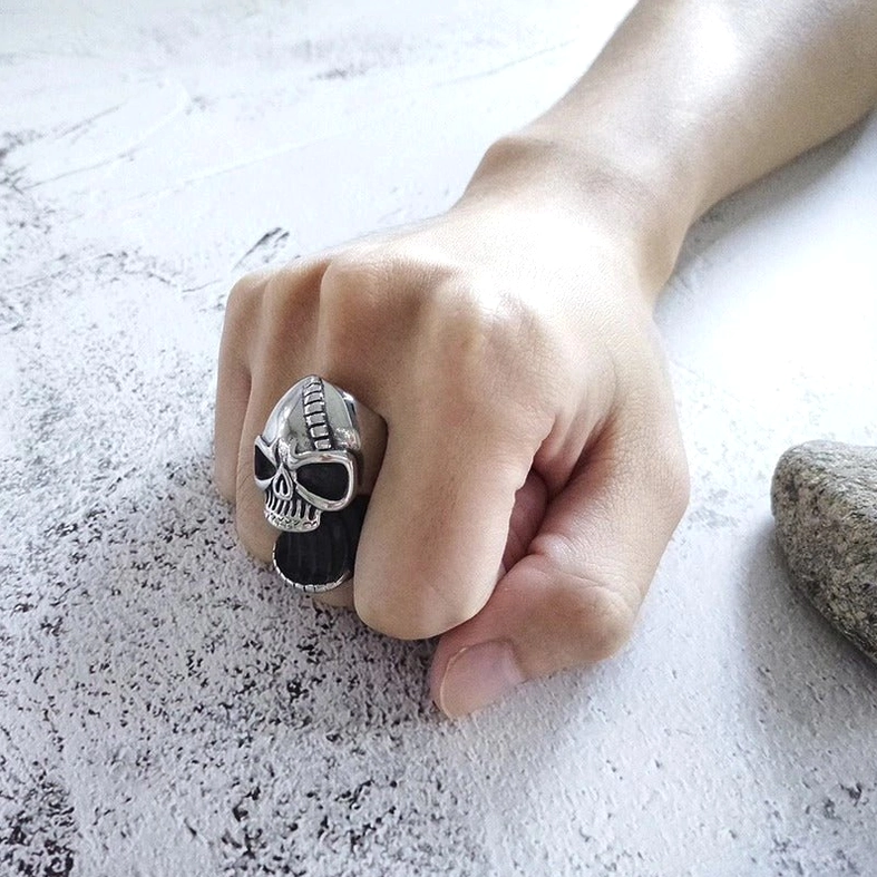 Close-up detail of skull ring carving and polished stainless steel finish with vintage patina