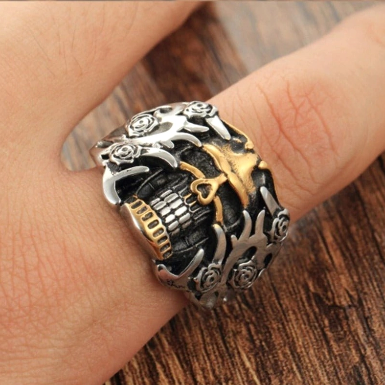 Skull rose gothic ring worn on finger side view, showing real wearing effect and three-dimensional details, dual-tone silver and gold memento mori design