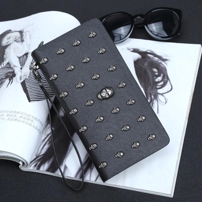 Zip-up skull studded purse angled front view - gothic long wallet showing multiple skull decorations and closure detail