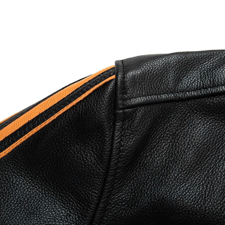 Sleeve stripe detail showing dual orange accents on black pebbled leather gothic jacket