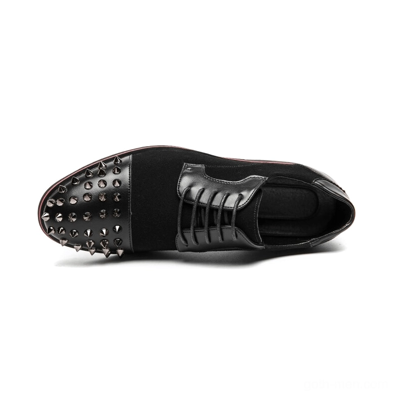 Close-up side view of spiked gothic derby shoe showing detailed metal spike studs and toe cap construction