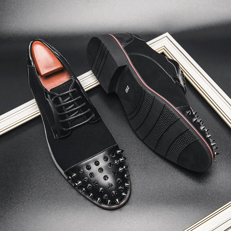 Top-down flat lay view of men's black spiked gothic derby shoes showing overall design and spike placement