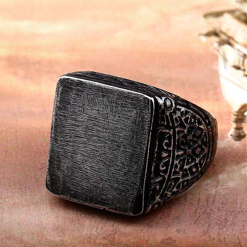 Matte black stainless steel square gothic ring overhead front view with carved ornaments