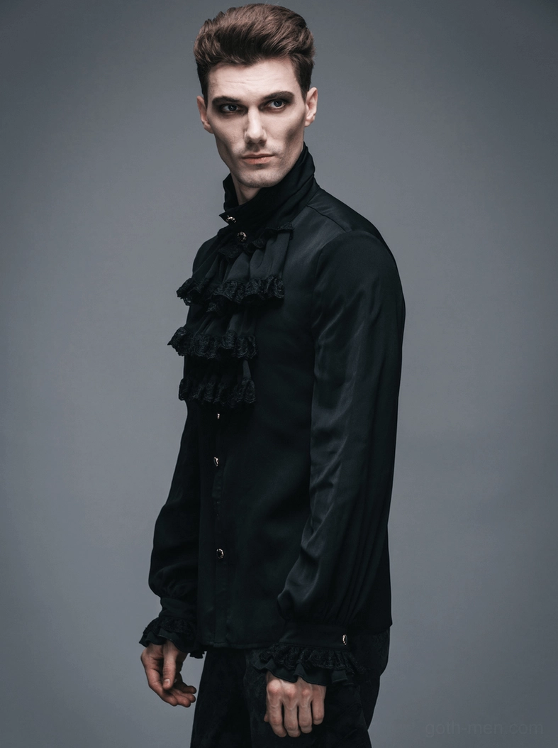 Side profile of man wearing black steampunk formal shirt with Victorian ruffles, styled with dark patterned trousers