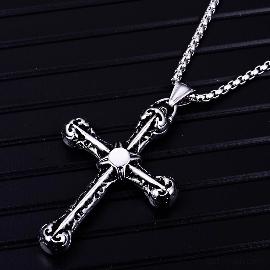 925 sterling silver ornate cross pendant with engraved patterns and round center accent against striped background